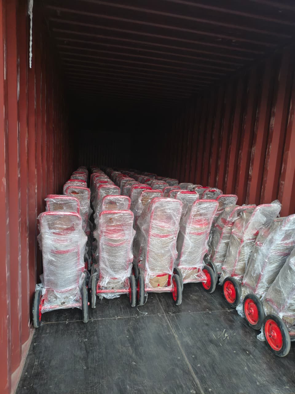 Wheeled fire extinguisher trolleys loaded in a shipping container